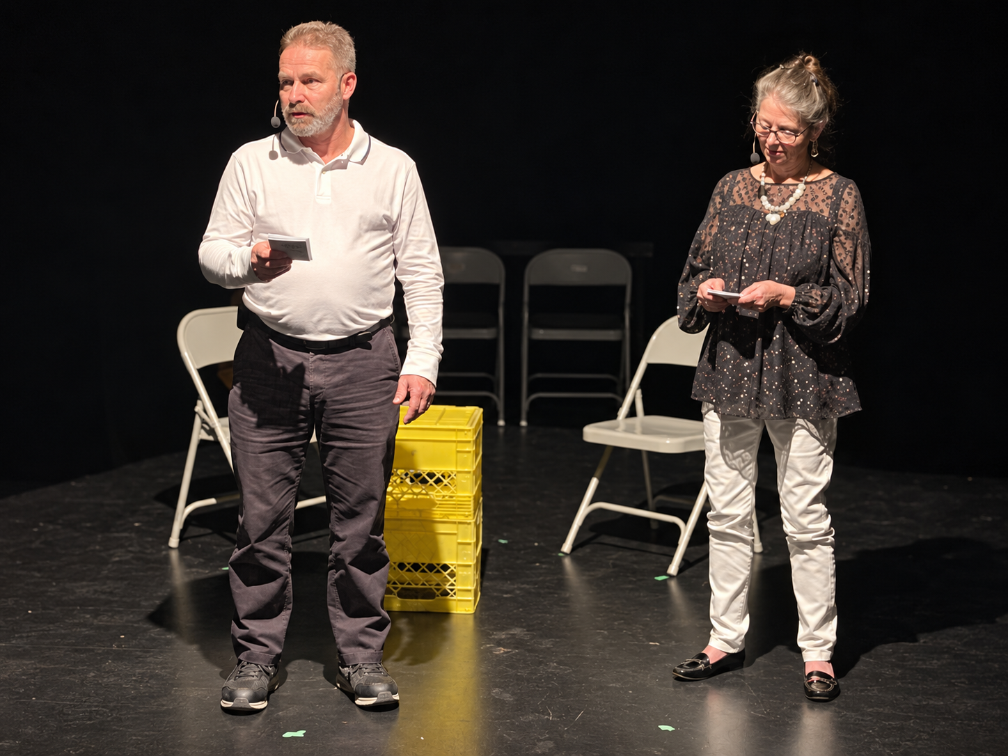 Jo on stage in a theatre production with bilingual narration